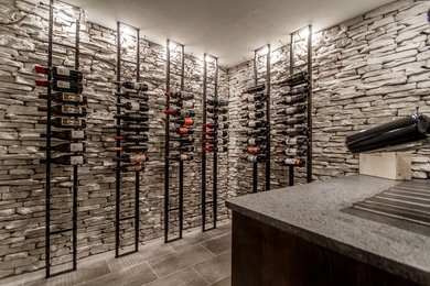 Example of a beach style wine cellar design in Little Rock
