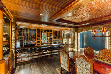 Huge elegant porcelain tile wine cellar photo in New York with storage racks