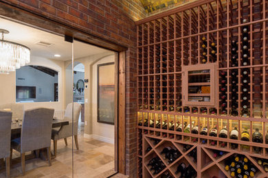 Wine cellar - large traditional travertine floor wine cellar idea in Phoenix with diamond bins
