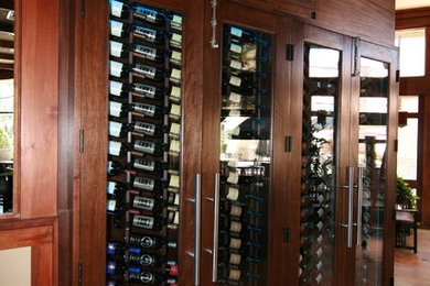 Inspiration for a mid-sized timeless ceramic tile wine cellar remodel in Los Angeles with display racks