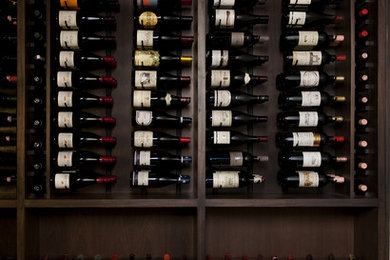Photo of a large classic wine cellar in Austin with display racks.