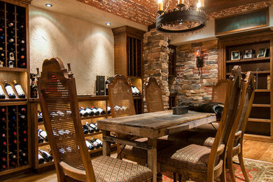 Medium sized rustic wine cellar in Raleigh with dark hardwood flooring and storage racks.