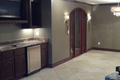 Inspiration for a large timeless vinyl floor and brown floor wine cellar remodel in Birmingham with storage racks
