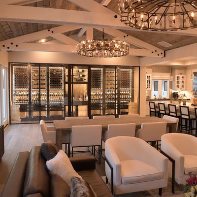Inspiration for a large contemporary medium tone wood floor and brown floor wine cellar remodel in Orange County with display racks