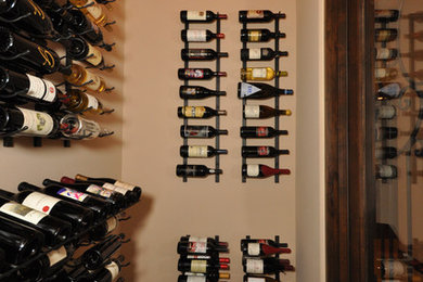 Example of a small trendy wine cellar design in San Diego with display racks
