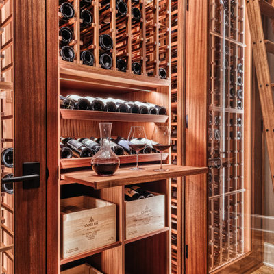 Example of a small arts and crafts cork floor wine cellar design in Portland with storage racks