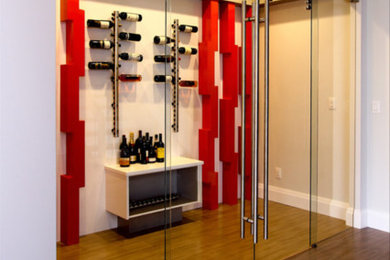 Wine cellar - mid-sized modern brown floor wine cellar idea in Edmonton with display racks
