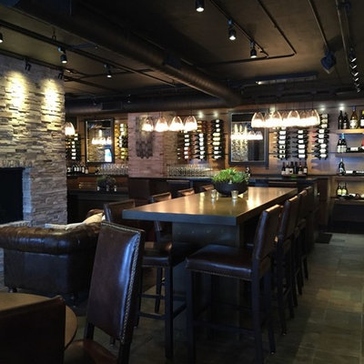 Example of a large arts and crafts wine cellar design in San Francisco with display racks