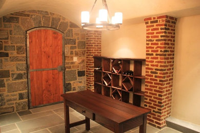 Inspiration for a mid-sized timeless slate floor and gray floor wine cellar remodel in New York with storage racks