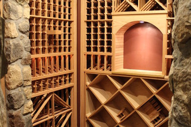 Inspiration for a mid-sized timeless concrete floor wine cellar remodel in Denver with storage racks