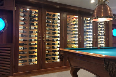 Inspiration for a contemporary wine cellar in Boston with display racks and beige floors.