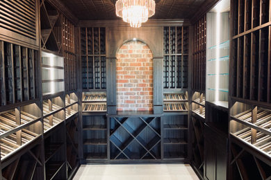Mid-sized tuscan travertine floor and white floor wine cellar photo in Dallas with display racks