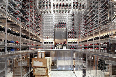Example of a large minimalist linoleum floor and white floor wine cellar design in San Francisco with storage racks
