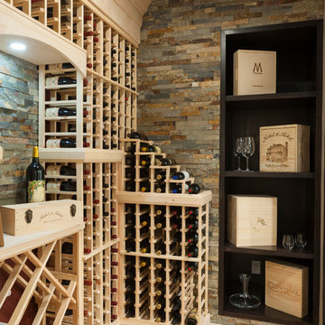 Traditional Wine Cellar w/ Stone Accent Walls, Wine Glass Storage, & A Cork Floo