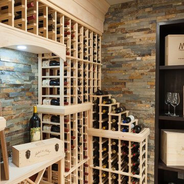 Traditional Wine Cellar with Stone Accent Wall and Wine Glass Storage
