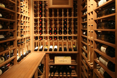 Inspiration for a classic wine cellar in Toronto with storage racks and brick flooring.