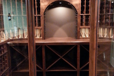 Inspiration for a timeless light wood floor wine cellar remodel in Austin with storage racks