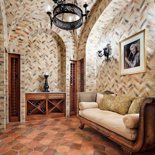 Diseño de bodega mediterránea con suelo de baldosas de terracota y botelleros de rombos