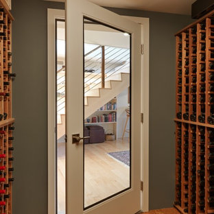 Wine cellar - mid-sized 1950s cork floor wine cellar idea in Burlington with storage racks