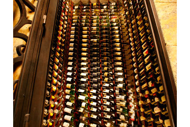 Large marble floor wine cellar photo in Los Angeles with display racks