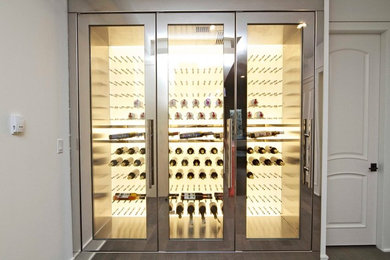 Medium sized modern wine cellar in Vancouver with storage racks.