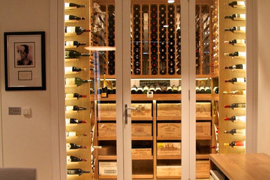 Inspiration for a contemporary wine cellar in Surrey.