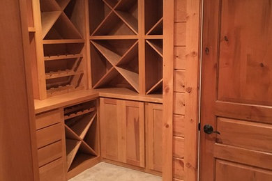 Wine cellar - mid-sized traditional porcelain tile wine cellar idea in Chicago with diamond bins