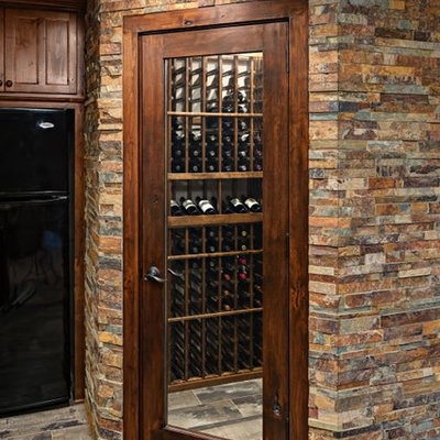 Large arts and crafts wine cellar photo in Minneapolis with storage racks