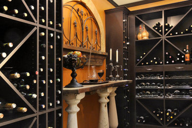 Medium sized mediterranean wine cellar in New York with cork flooring and cube storage.