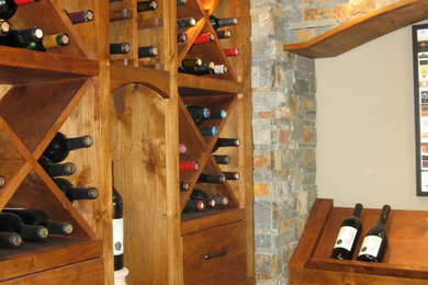 Inspiration for a mid-sized rustic porcelain tile wine cellar remodel in Portland with display racks