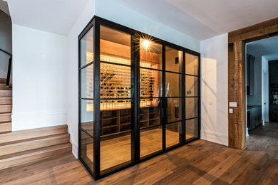 Inspiration for a large dark wood floor and brown floor wine cellar remodel in Charlotte with storage racks