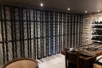 Inspiration for a large rustic porcelain tile and gray floor wine cellar remodel in Toronto with display racks