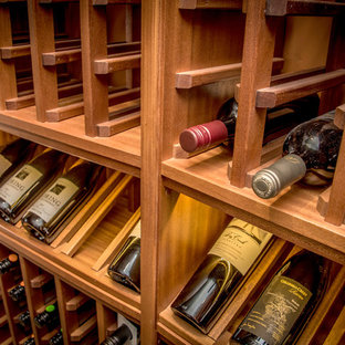 Esempio di una piccola cantina mediterranea con rastrelliere portabottiglie e pavimento giallo