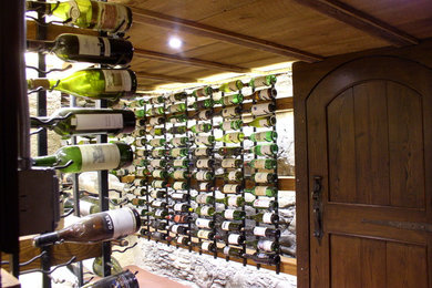 Example of an eclectic wine cellar design in Other