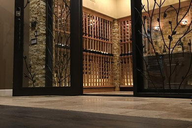 Inspiration for a huge contemporary limestone floor wine cellar remodel in Phoenix with storage racks
