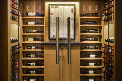 Inspiration for a small contemporary wine cellar in Toronto with dark hardwood flooring and display racks.