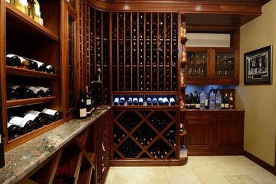 Wine cellar - mid-sized traditional porcelain tile wine cellar idea in New York with storage racks