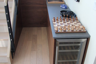 Wine cellar - small contemporary light wood floor and beige floor wine cellar idea in New York