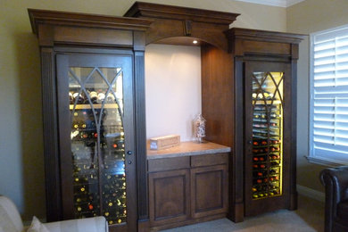 Inspiration for a mid-sized craftsman carpeted and beige floor wine cellar remodel in San Francisco with storage racks
