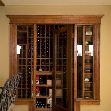 Wine room entry with glass door, glass sidelights, and wine bottle display shelv