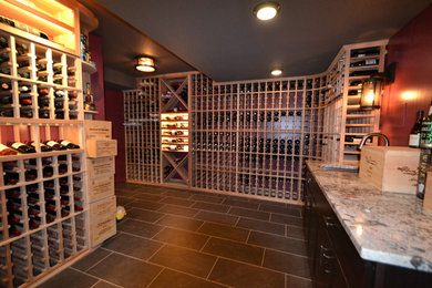 Photo of a medium sized bohemian wine cellar in Baltimore with ceramic flooring, storage racks and black floors.