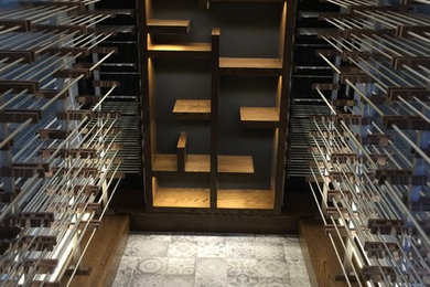 Design ideas for a medium sized contemporary wine cellar in Toronto with storage racks, ceramic flooring and white floors.