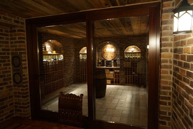 Design ideas for a medium sized contemporary wine cellar in Toronto with storage racks, ceramic flooring and beige floors.