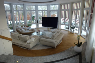 Inspiration for a traditional conservatory in Other with medium hardwood flooring, a standard ceiling and brown floors.