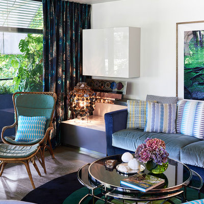 Inspiration for a mid-sized eclectic enclosed dark wood floor and brown floor family room remodel in Munich with white walls, no fireplace and no tv