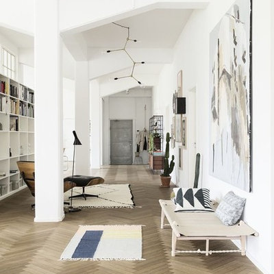 Example of a danish open concept painted wood floor family room design in Nuremberg with white walls, no fireplace and no tv