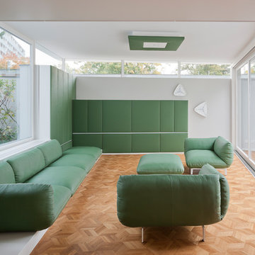 Die grünen Möbel von Cor spiegeln sich in der Bespannung der Wandelemente wider