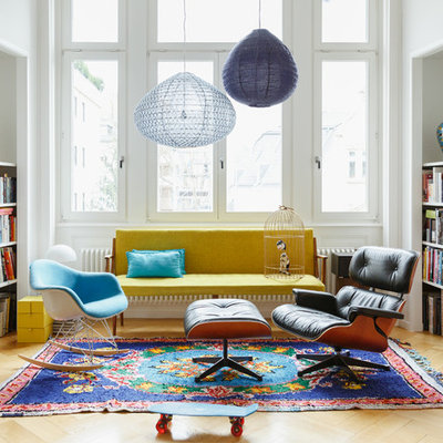 Family room library - mid-sized eclectic enclosed light wood floor and beige floor family room library idea in Berlin with white walls