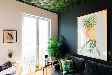 Kleines, Fernseherloses Mid-Century Wohnzimmer ohne Kamin mit hellem Holzboden, braunem Boden und grüner Wandfarbe in Hamburg