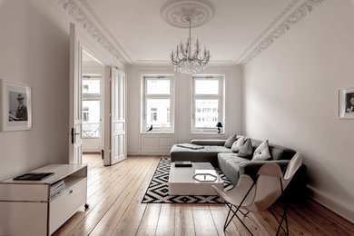 ハンブルクにある北欧スタイルのおしゃれなリビング (白い壁、無垢フローリング、茶色い床) の写真